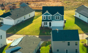 Aerial view of a new Florida housing development with modern two-story homes and active construction nearby.