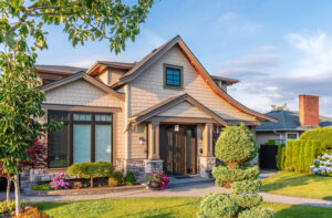 Front view of a craftsman-style house with stone accents and a manicured garden representing home resale value.